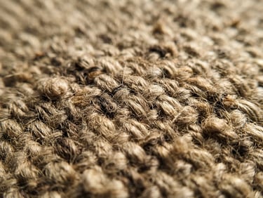 Macro close-up of heavy-weight raw oatmeal linen fabric weave, warm afternoon window light, deep soft shadows, 35mm photography
