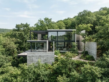 Elegant architectural photography of a minimalist concrete and glass villa, bright natural daylight, soft blue sky with light clouds, lush green forest surroundings, 35mm.