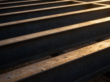 Extreme close-up of architectural blueprints overlaid on raw steel beams, low-angle golden hour light, 35mm.
