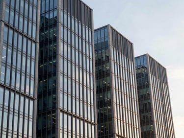 Architectural details of a modern financial district building at golden hour, focus on geometric lines and glass, soft natural light, professional editorial, 35mm lens