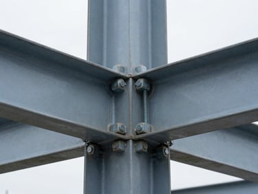 Macro close-up of a heavy steel bolted connection joint, crisp technical photography, cool overcast daylight, sharp focus, 35mm