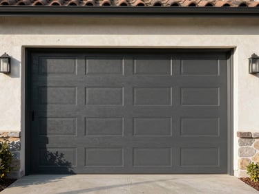 Straight-on architectural shot of a modern charcoal-colored garage door on a stucco Sacramento home, clean lines, bright afternoon sun with crisp shadows.