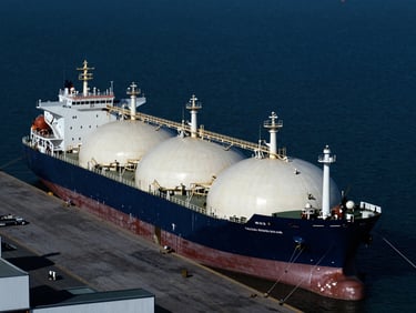 Industrial LNG carrier vessel docked at a high-tech terminal, low-key dramatic lighting, cold blue tones, sharp contrast