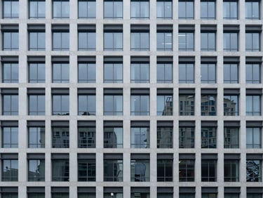 Modern commercial real estate facade, cool overcast light, sharp focus, minimalist composition.