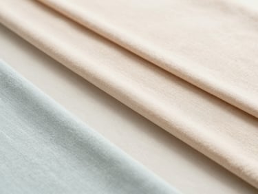 Textured flat-lay of various pastel fabric table runners, soft neutral background, gentle folds
