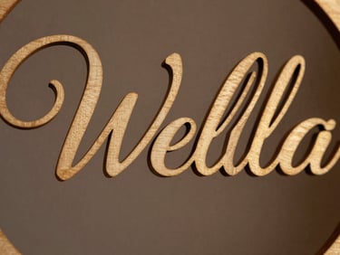 Macro photograph of elegant laser-cut wooden wedding sign, warm directional lighting, clean edges, luxury feel