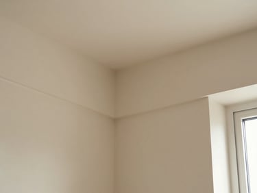 Close-up of seamless wall moulding corners on a sand-colored wall, clean joints, natural light.