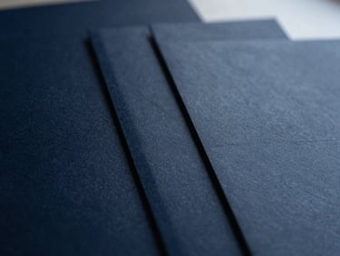 Macro photography of structured corporate documents, sharp focus, deep navy shadows, overcast light, 35mm