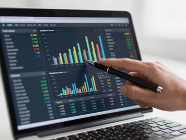 Close-up of a financial dashboard on a laptop screen showing bar charts and KPI metrics, a hand pointing at the screen with a pen, clean bright overhead lighting, no faces, technical and precise atmosphere