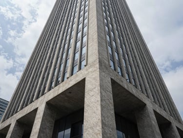 Wide-angle architectural geometry of a modern financial capital skyscraper, sharp concrete angles, overcast daylight, dramatic shadows.
