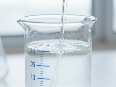 Close-up of a water testing beaker with clear water, showing a subtle mineral reintroduction process, scientific precision, diffused window light.