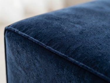 Macro shot of deep slate blue velvet upholstery texture under soft natural light, shallow depth of field