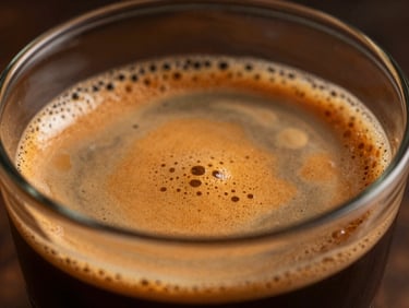 Extreme close-up of a perfectly pulled espresso shot with golden crema, warm side lighting, dark moody background, rich textures, shallow depth of field.