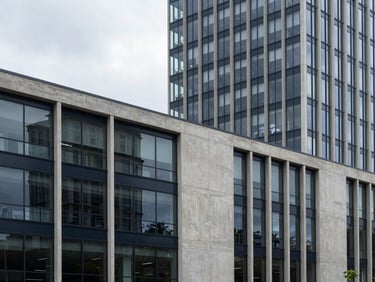 Architectural detail of a modern urban development in Bogota, clean concrete and glass facades, natural overcast daylight, professional 35mm photography