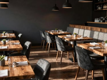 Moody Scandinavian-style restaurant dining room, empty wooden tables, deep morning shadows.