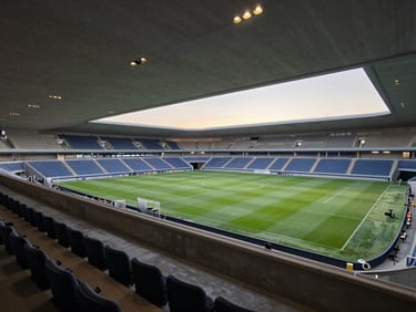 An empty VIP suite overlooking a pristine football pitch in Barcelona, modern architectural details, soft evening light