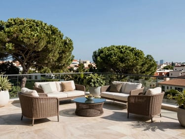 Sun-drenched luxury penthouse terrace in Turó Park, Barcelona, looking over green treetops under a clear blue sky, elegant outdoor furniture.