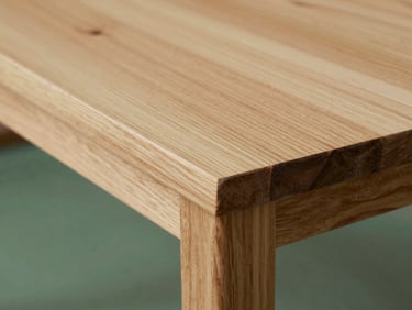 Close-up of raw certified walnut timber showing rich natural grain and flawless joinery under soft diffused daylight, 35mm