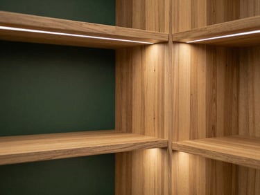 Bespoke walk-in closet with integrated warm LED lighting, natural cedar wood texture, minimalist shelving, 35mm