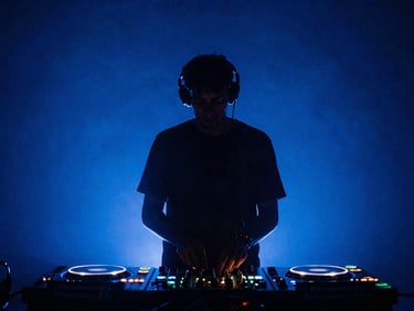 DJ silhouette behind glowing equipment decks, intense blue background lights, smoky atmosphere