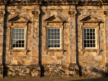 Historic stone architecture of the Jesuit Sanctuary in Anchieta, warm natural sunlight filtering through old windows, clean composition