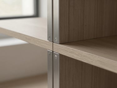 Close-up of a custom brushed steel furniture joint, grain-matched wood, architectural film photography style