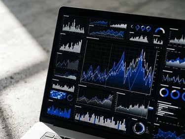 Tight macro shot of a real-time attribution dashboard on a high-resolution screen, bright side-light casting sharp shadows across a clean concrete workspace, cobalt blue data lines.