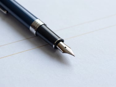 Close-up of a fountain pen on a financial document, subtle gold lines, cool diffused office daylight, sharp focus.