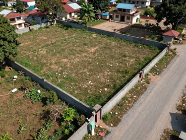 Drone shot of a residential land plot in Bhaktapur, showing a clean 4 Aana boundary with a gravel road on the side under bright natural daylight.