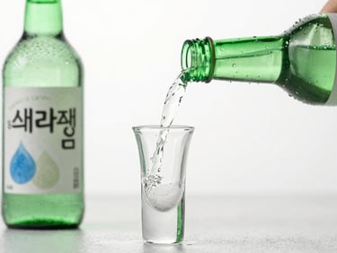 Condensation-beaded green soju bottle being poured into a traditional shot glass, bright studio lighting, cool emerald tones