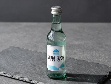 Sleek heavy-glass Ilpoom Jinro bottle on a dark slate surface, silver accents, cool natural daylight, sharp focus, medium format.