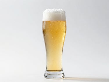 A crisp clean-finish lager in a tall glass with condensation, golden liquid, cool silver accents, bright commercial photography