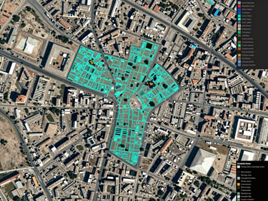 Top-down high-resolution satellite mapping interface of Erbil city center, displaying overlapping teal parcel boundary vectors and technical GIS data overlays.