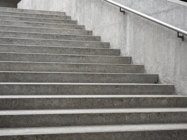 Abstract geometric concrete stairs rising upwards, clean architectural lines, soft daylight