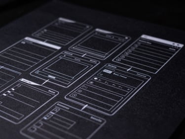 Stylized hand sketch of an Android app wireframe on dark paper, sharp white lines, low-key lighting, technical blueprint aesthetic