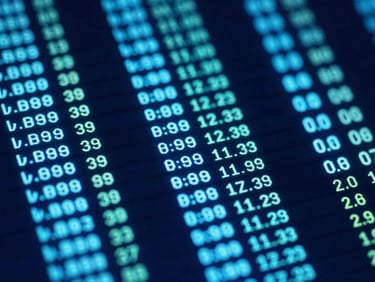 Macro shot of a glowing digital screen displaying financial data in a monospaced font, neon-cyan and indigo accents, high-contrast tech aesthetic.