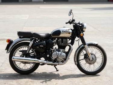 Royal Enfield Classic 350 in three-quarter front angle on concrete floor, north-facing daylight, chrome details and spoke wheels visible, no rider
