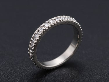 Extreme close-up of a platinum vintage-style engagement ring with detailed milgrain borders and hand-set micro-pave stones, high-contrast studio lighting
