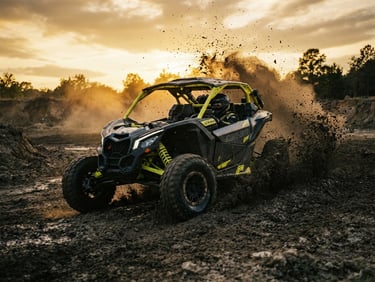 Dynamic low-angle action shot of a high-performance UTV kicking up dramatic mud and dust trails at golden hour, high-contrast dark tones with bright yellow accents, 35mm photography