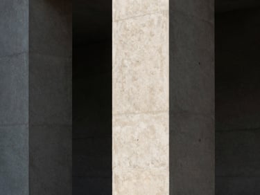 Minimalist architectural detail of concrete pillars and deep shadows, high-contrast natural light, sharp geometric angles