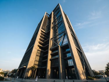 Low-angle architectural photography of a modern concrete and glass facade in Abu Dhabi, sharp morning light casting long dramatic shadows, deep obsidian tones with warm sand highlights, 35mm lens.