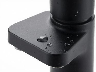 Close-up of a matte black faucet surface with micro water droplets, perfect metallic texture, soft studio lighting