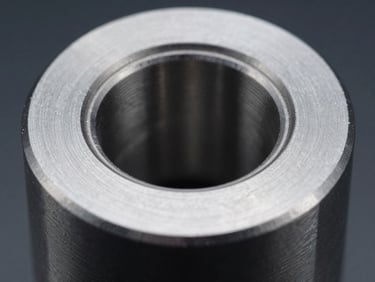 Macro shot of a freshly machined stainless steel part, showcasing its smooth, reflective surface under cool industrial lighting, sharp details