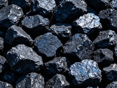 Close-up of glossy, dark industrial coal lumps, high-contrast cool daylight, deep blue and slate tones, sharp details, wide-angle lens