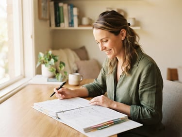 A professional dietician in a clean, soft-lit workspace reviewing clinical charts, warm editorial photography, 35mm, shallow depth of field.