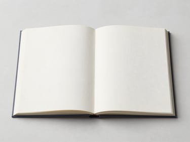 An open art book showing classical sculptures, clean marble background, diffused gallery lighting, 35mm