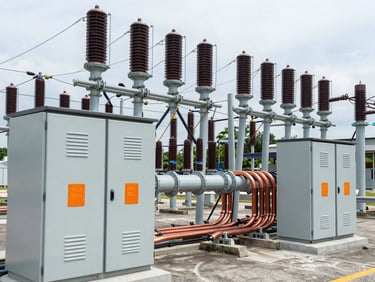 Crisp technical shot of high-voltage electrical panels and heavy copper busbars inside a Singapore substation, cool steel tones, orange safety tags