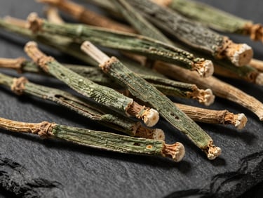 Macro close-up of raw dried ashwagandha roots on a dark slate surface, soft morning side-light, high-contrast textures