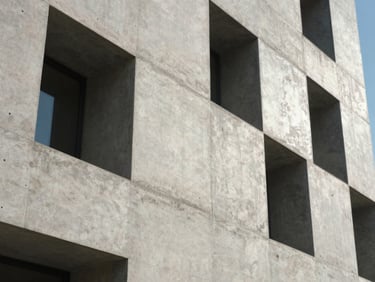 Close-up of a modern architectural concrete facade with sharp shadows, high-contrast daylight, clean lines, technical precision