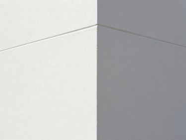 Straight-on architectural shot of a freshly repaired drywall corner, perfectly smooth texture, sharp crisp paint lines, bright daylight, 35mm lens